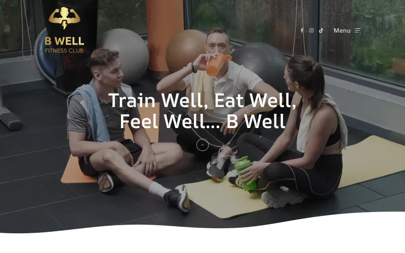 Homepage of the B Well Fitness Club website, with the club's gold logo and the tagline Train Well, Eat Well, Feel Well over a photo of members in the gym